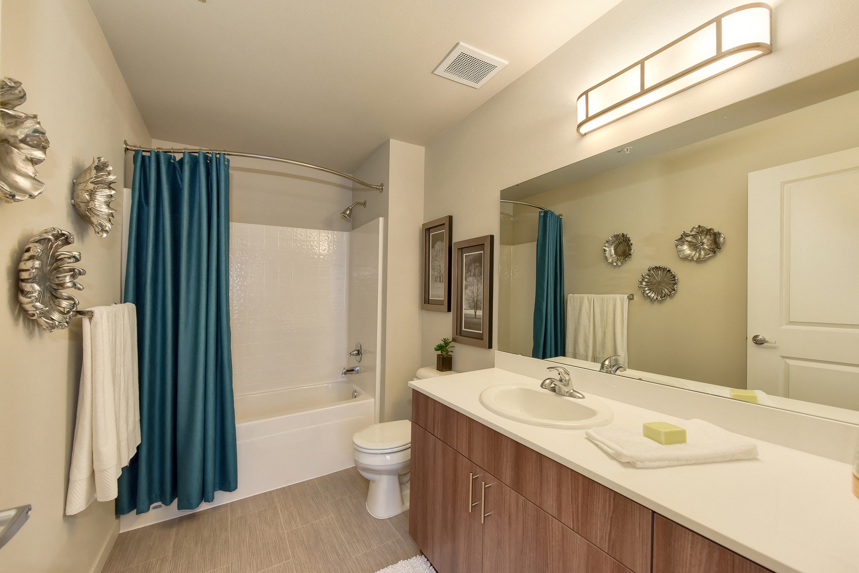 Master Bathroom with Vanity, Bath/Shower, Blue Curtains, Toilet, Wood Inspired Floor